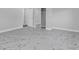 Light and bright empty bedroom with white marble floors, light grey paint, and a mirrored closet for ample storage at 5440 Quist Dr, Port Richey, FL 34668