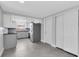 Modern kitchen featuring gray cabinets, stainless steel appliances, and herringbone tile floors at 5440 Quist Dr, Port Richey, FL 34668