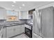 Modern kitchen featuring white cabinets, stainless steel appliances, and stylish backsplash at 5440 Quist Dr, Port Richey, FL 34668