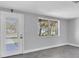 Renovated living room featuring a door to the outside and a view through a window at 5440 Quist Dr, Port Richey, FL 34668