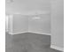 Spacious living room with herringbone floors, a modern light fixture, and neutral paint at 5440 Quist Dr, Port Richey, FL 34668