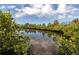 Enjoy scenic water views with lush green foliage reflecting the sky in this tranquil setting at 5440 Quist Dr, Port Richey, FL 34668