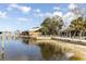 Scenic waterfront area featuring docks, sandy shores, and a covered shelter at 5440 Quist Dr, Port Richey, FL 34668