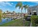 Manicured backyard featuring a dock, lush lawn, and landscaping, leading to serene canal views at 5815 Dory Way, Tampa, FL 33615
