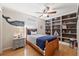 Nautical-themed bedroom with built-in bookshelves and a comfortable bed at 5815 Dory Way, Tampa, FL 33615