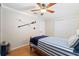 Coastal-themed bedroom with hardwood floors and a ceiling fan at 5815 Dory Way, Tampa, FL 33615