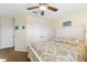 Bright bedroom with a ceiling fan, light walls, and a comfortable-looking bed at 5815 Dory Way, Tampa, FL 33615