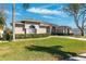 Lovely home boasting a lush lawn, mature trees, and an attached garage for convenient parking at 5815 Dory Way, Tampa, FL 33615