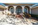 Elegant home entrance with a brick walkway, arched windows, and stately columns for curb appeal at 5815 Dory Way, Tampa, FL 33615