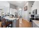 Modern kitchen featuring white cabinets, stainless steel appliances, and a breakfast bar overlooking the living area at 5815 Dory Way, Tampa, FL 33615