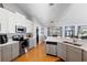 Contemporary kitchen with stainless appliances and quartz countertops, open to dining area at 5815 Dory Way, Tampa, FL 33615