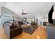 Bright living room features a fireplace, ceiling fan, wood floors, and sliding glass doors to the outdoor area at 5815 Dory Way, Tampa, FL 33615