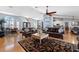 The bright living room offers a comfortable space with two sofas, natural light, and a ceiling fan at 5815 Dory Way, Tampa, FL 33615
