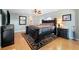 Comfortable main bedroom showcasing dark wood furniture, ceiling fan, and neutral walls at 5815 Dory Way, Tampa, FL 33615