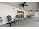 Covered patio features a ceiling fan, comfortable seating, and sliding glass doors leading inside to the home at 5815 Dory Way, Tampa, FL 33615