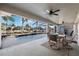 Covered patio with pool views, perfect for outdoor entertaining and relaxation at 5815 Dory Way, Tampa, FL 33615