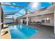 Relaxing screened-in pool area with ample seating and outdoor dining space for enjoyable outdoor living at 5815 Dory Way, Tampa, FL 33615