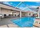 Enjoy the inviting screened-in pool with comfortable seating for relaxation and leisure at 5815 Dory Way, Tampa, FL 33615