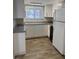 Bright kitchen featuring stainless steel appliances, granite countertops, and ample cabinet space at 6308 Newtown Cir # 8A3, Tampa, FL 33615
