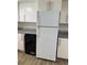 Kitchen features a refrigerator, black dishwasher and updated counter tops at 6308 Newtown Cir # 8A3, Tampa, FL 33615