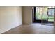 A spacious room with wood floors and sliding glass door at 6308 Newtown Cir # 8A3, Tampa, FL 33615