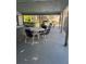 Outdoor lounge area with tables and chairs, perfect for relaxing by the pool at 6308 Newtown Cir # 8A3, Tampa, FL 33615