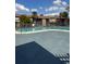 Community pool with lounge chairs and shade trees under a sunny sky at 6308 Newtown Cir # 8A3, Tampa, FL 33615