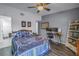 Cozy bedroom featuring a ceiling fan, desk area, and a comfortable bed with nautical-themed pillows and striped bedspread at 6311 93Rd N Ter # 4403, Pinellas Park, FL 33782