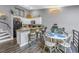 Bright kitchen features bar seating, modern appliances, and adjacent dining area with gray walls and wood floors at 6311 93Rd N Ter # 4403, Pinellas Park, FL 33782