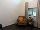 Cozy living room with patterned armchair, side table, and window with decorative curtains at 6311 93Rd N Ter # 4403, Pinellas Park, FL 33782