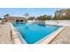 Community pool is surrounded by a deck and fencing at 6311 93Rd N Ter # 4403, Pinellas Park, FL 33782