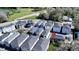 Aerial view of colorful townhomes surrounded by lush landscaping, showcasing community living near a lake at 637 Jetstar Ln, Oldsmar, FL 34677