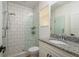 Bathroom featuring tiled shower with glass door, granite countertop, and modern fixtures at 637 Jetstar Ln, Oldsmar, FL 34677