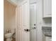En-suite half-bathroom with granite counters and white doors and trim at 637 Jetstar Ln, Oldsmar, FL 34677