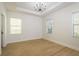 Spacious and bright bedroom with a tray ceiling and vinyl plank flooring at 637 Jetstar Ln, Oldsmar, FL 34677
