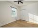 Bright bedroom featuring modern ceiling fan, wood flooring, and large window at 637 Jetstar Ln, Oldsmar, FL 34677