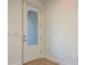Bright entryway featuring light wood floors and a door with glass panel at 637 Jetstar Ln, Oldsmar, FL 34677