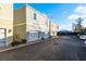 Townhome exterior with individual garages and well-maintained landscaping at 637 Jetstar Ln, Oldsmar, FL 34677
