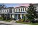 Charming two-story home featuring blue siding, black shutters, and a welcoming front porch with well-maintained landscaping at 637 Jetstar Ln, Oldsmar, FL 34677