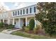 Two-story exterior elevation with covered porch, landscaping, and modern fixtures at 637 Jetstar Ln, Oldsmar, FL 34677