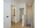 Well-lit hallway with doors to bathrooms and closets, featuring hardwood floors and neutral paint at 637 Jetstar Ln, Oldsmar, FL 34677