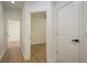 Bright hallway featuring wood-look flooring and white doors leading to various rooms in the home at 637 Jetstar Ln, Oldsmar, FL 34677