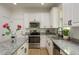 Close-up of modern kitchen details including granite counters, stainless appliances and white cabinets at 637 Jetstar Ln, Oldsmar, FL 34677
