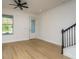 Bright living room with light wood floors, modern ceiling fan, and ample natural light at 637 Jetstar Ln, Oldsmar, FL 34677