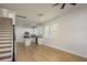 Bright living room with hardwood floors and an open layout connected to the kitchen area at 637 Jetstar Ln, Oldsmar, FL 34677