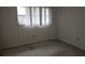 Bedroom featuring window with blinds and aged carpet at 7060 Lafayette St # 7060, Pinellas Park, FL 33781
