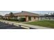 Exterior view of a community clubhouse featuring a neatly landscaped lawn and convenient parking at 7060 Lafayette St # 7060, Pinellas Park, FL 33781