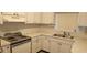 Well-organized kitchen with vintage stove and ample counter space for meal preparation at 7060 Lafayette St # 7060, Pinellas Park, FL 33781