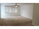 Spacious living room with large window offering natural light and neutral walls at 7060 Lafayette St # 7060, Pinellas Park, FL 33781
