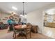 Dining room with a round table, chairs, and decorative lighting fixture, adjacent to the living room and kitchen at 7437 118Th Dr, Largo, FL 33773